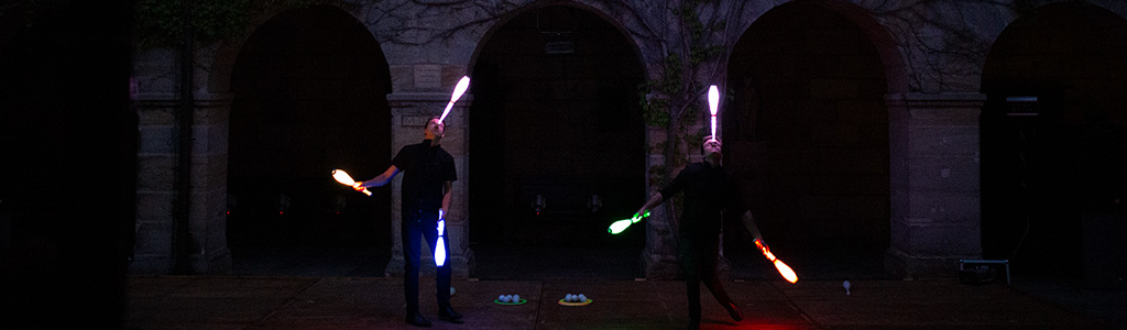 Daniel and Julius balancing led club on nose on stage